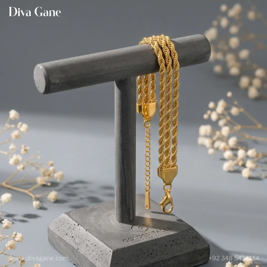 gold liquid chain statement bracelet with bar tassel Detailed view of the gold lobster clasp, triangular end caps, and adjustable extender chain of a triple-strand bracelet