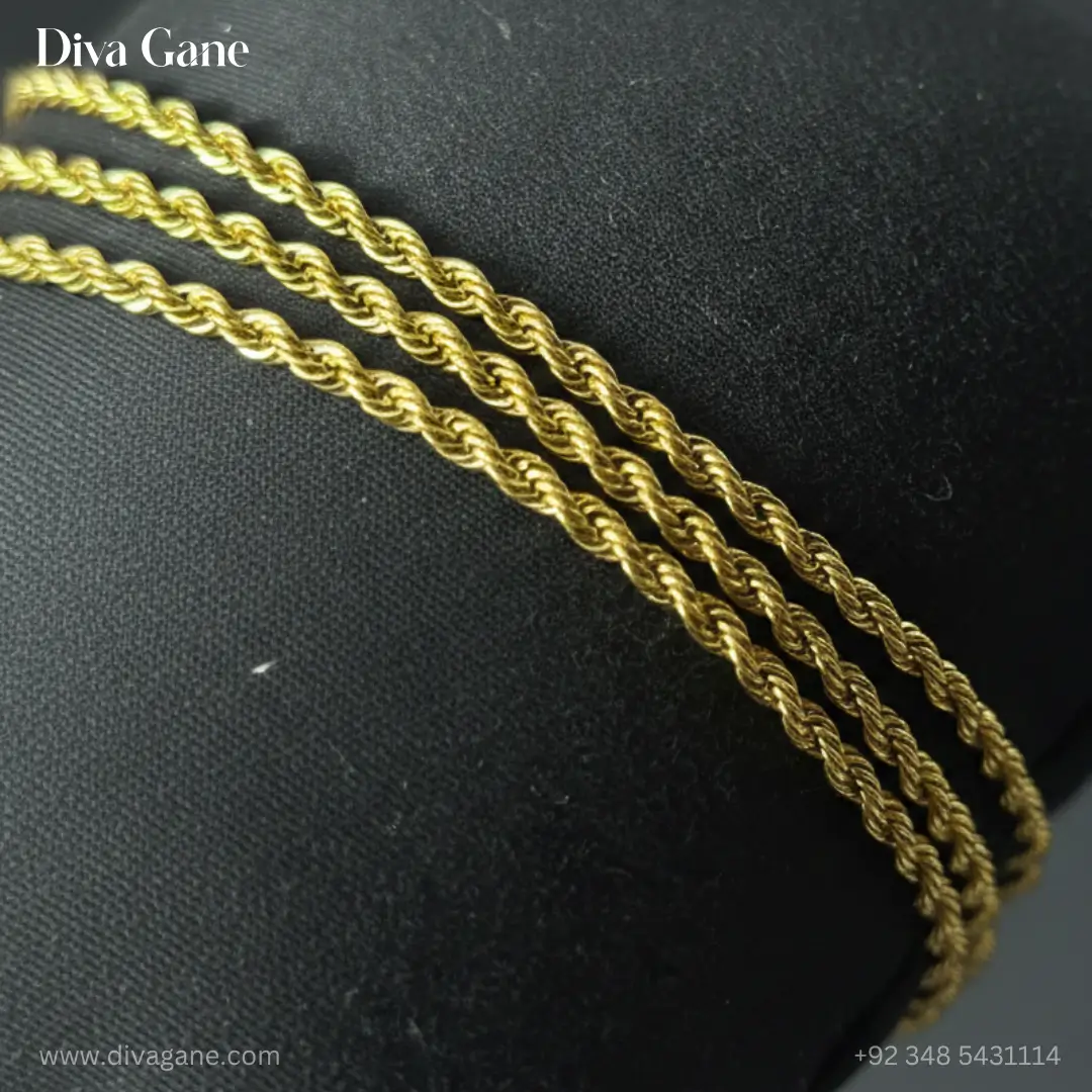 gold liquid chain statement bracelet with bar tassel Close-up of three parallel gold rope chains showing the intricate twisted texture on a black jewelry cushion.