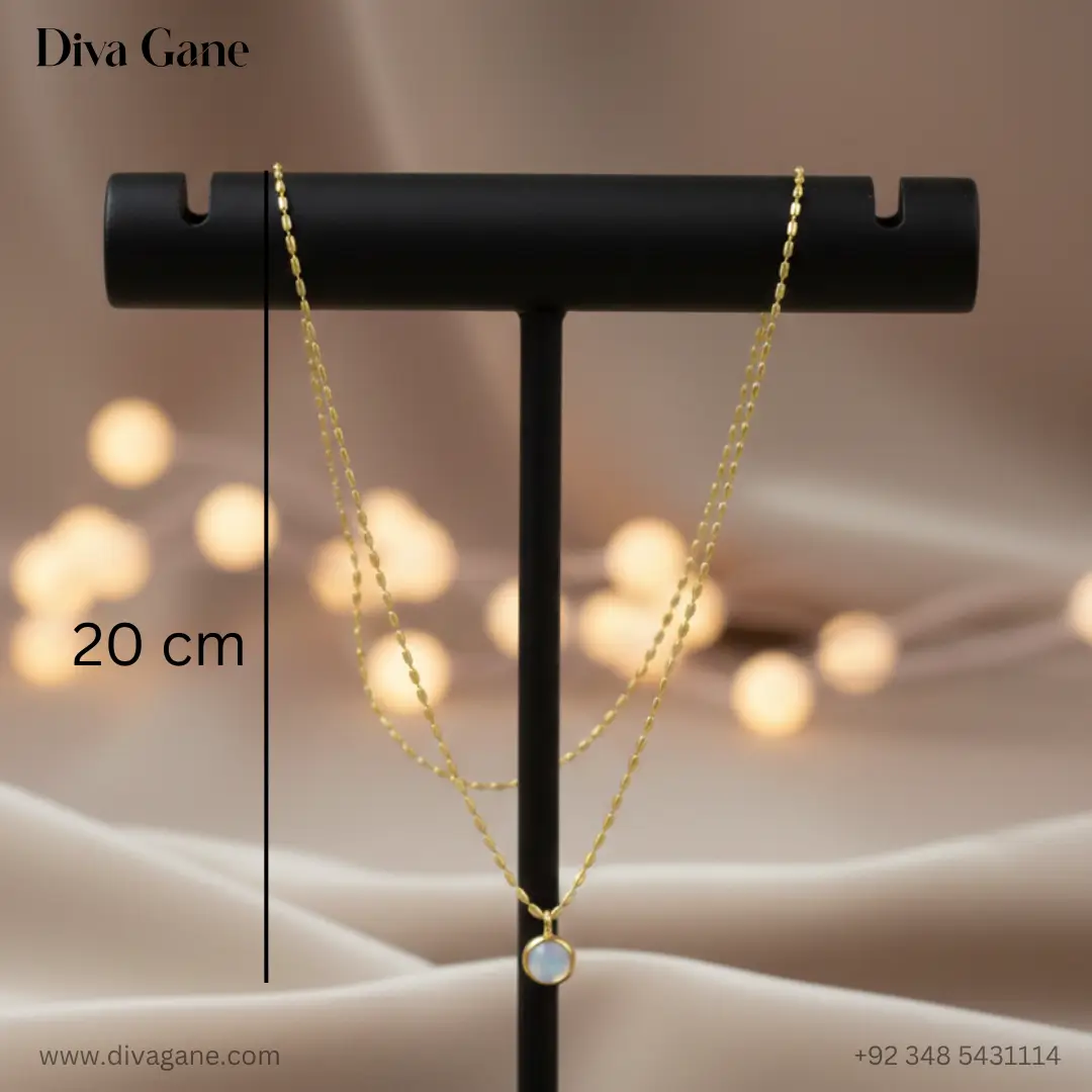 the luna minimalist moonstone pendant A single-strand gold pendant necklace displayed on a professional black T-bar jewelry stand against a draped satin backdrop