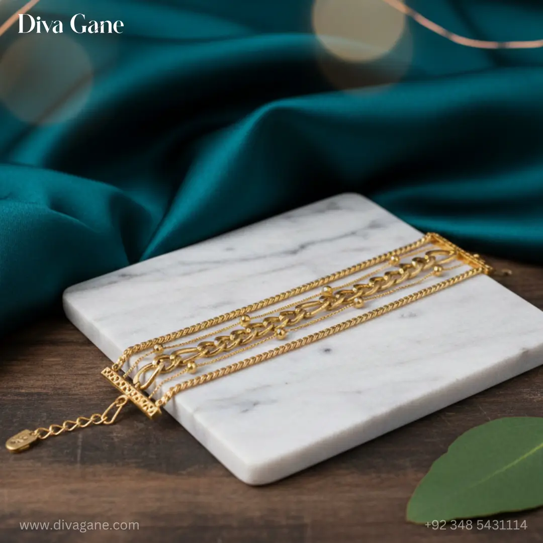 gold harmony layered bracelet High-fashion gold multi-strand bracelet featuring five different chain styles laid out on marble