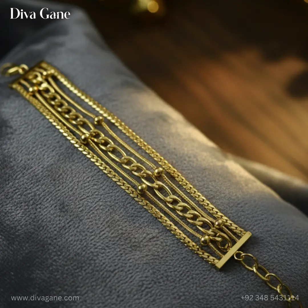 gold harmony layered bracelet High-fashion gold multi-strand bracelet featuring five different chain styles laid out on black silk fabric.