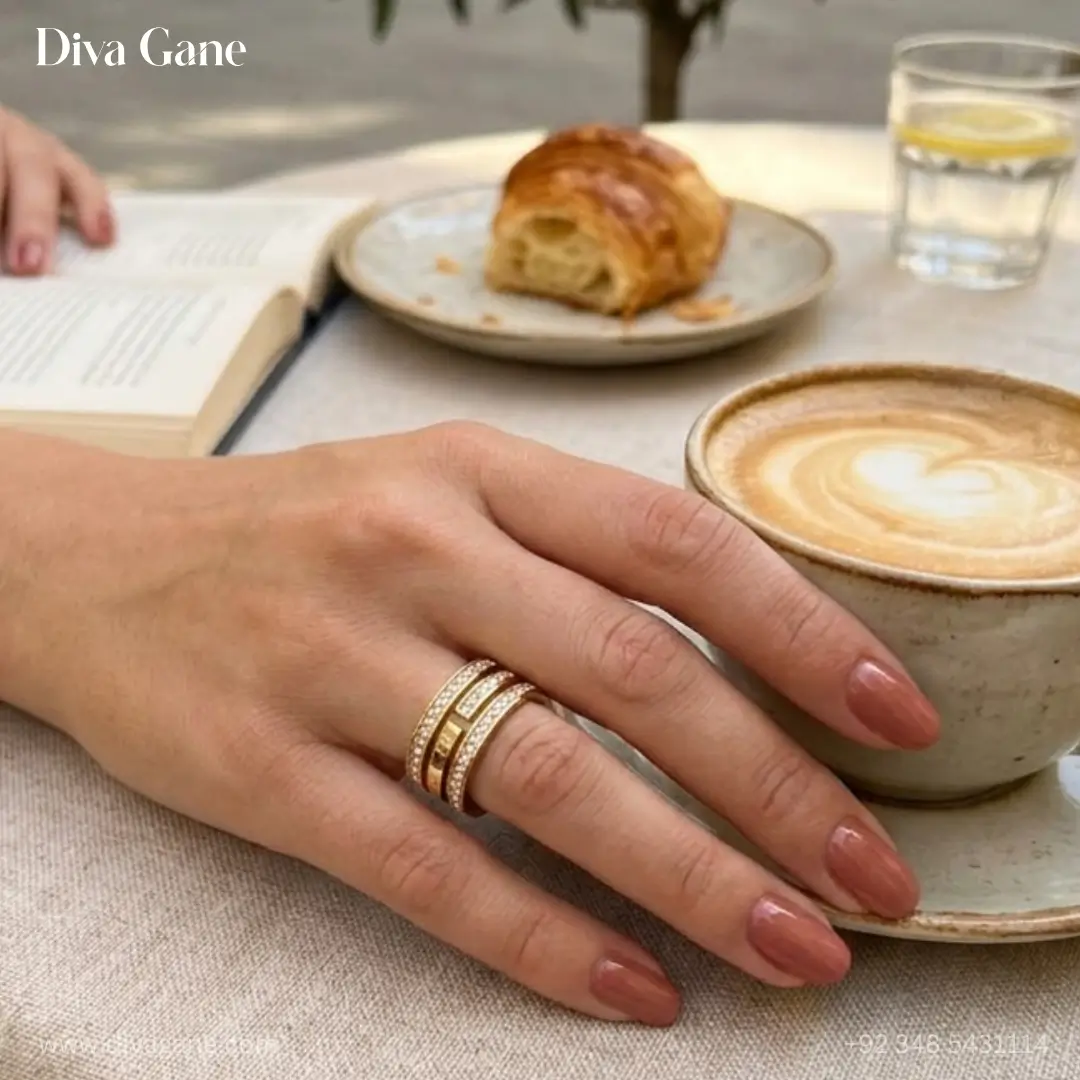luxe 18k gold plated triple layer pavé statement ring A detailed view of a triple-layered gold statement ring worn by a model holding a cup of coffee